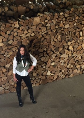 Miss Hybrid live from the woodshed in thigh boots and cleavage revealing blouse.